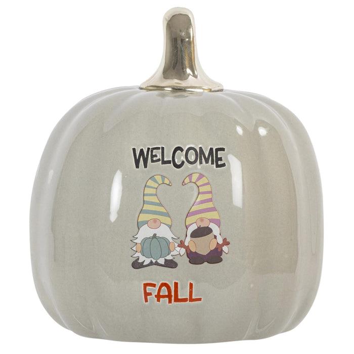 A glossy ceramic decorative pumpkin with a metallic gold stem, featuring a 'WELCOME FALL' gnome illustration on the front.