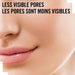 Close-up of a person's lower face with text at the top reading 'LESS VISIBLE PORES / LES PORES SONT MOINS VISIBLES' in black sans-serif lettering.