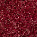 Close-up of red seed beads with a blurred background