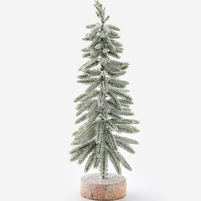 A small flocked Christmas tree with light green needles and white snow-like dusting, mounted on a round textured base, photographed against a clean white background.