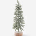 A small flocked Christmas tree with light green needles and white snow-like dusting, mounted on a round textured base, photographed against a clean white background.