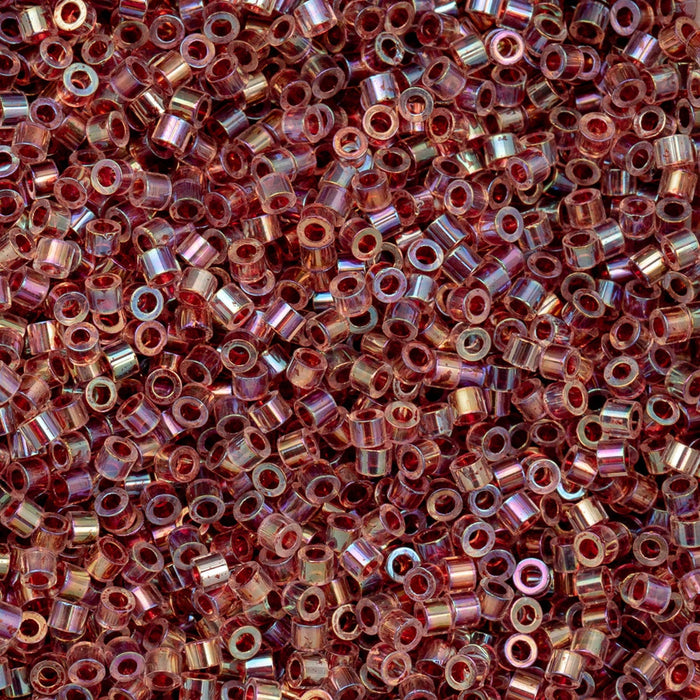 Close-up of small metallic beads in various shades of red and gold.