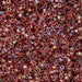 Close-up of small metallic beads in various shades of red and gold.