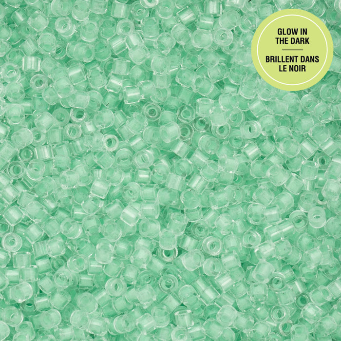 Green glow-in-the-dark beads on a green background with a label.