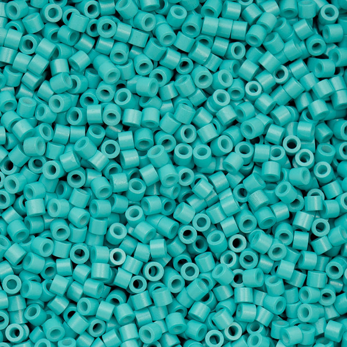 Turquoise plastic beads scattered on a flat surface