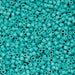 Turquoise plastic beads scattered on a flat surface