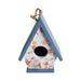 Floral-patterned birdhouse with a blue roof on a white background