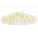 White MDF wall plaque with the words “Home Sweet Home” in bold yellow letters, decorated with lemon and leaf illustrations.