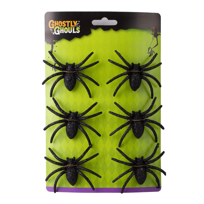 Pack of six black plastic fake spiders on a bright lime green and black Ghostly Ghouls retail card, photographed against a plain white background.