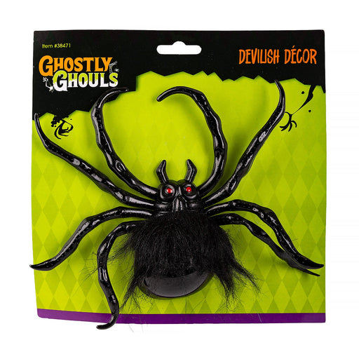 A packaged Halloween decoration featuring a large black spider with hairy legs and red eyes on a bright lime green card backing. The packaging reads 'Ghastly Ghouls' and 'Devilish Décor'.