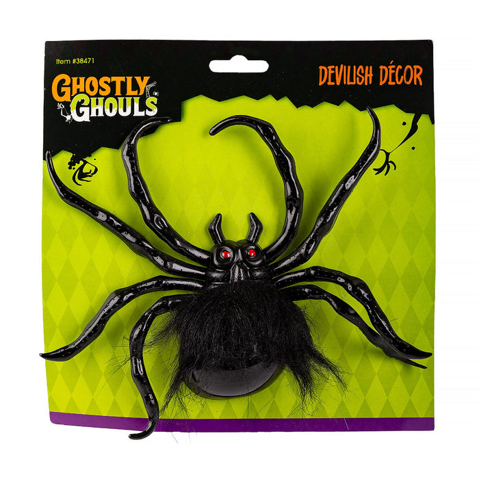 A packaged Halloween decoration featuring a large black spider with hairy legs and red eyes on a bright lime green card backing. The packaging reads 'Ghastly Ghouls' and 'Devilish Décor'.