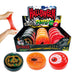Halloween-themed plastic putty discs displayed in a retail box with three sample discs in front. A hand is stretching red putty on the left.