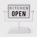 White sign with 'KITCHEN OPEN' text on a white background