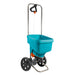 Blue lawn spreader with wheels on a white background