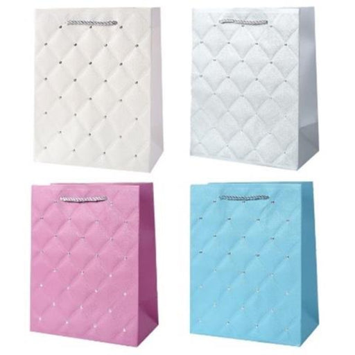 Four quilted paper shopping bags arranged in a 2x2 grid on a white background, featuring diamond-quilted patterns with small rhinestone-like accents in white, silver, pink, and light blue.