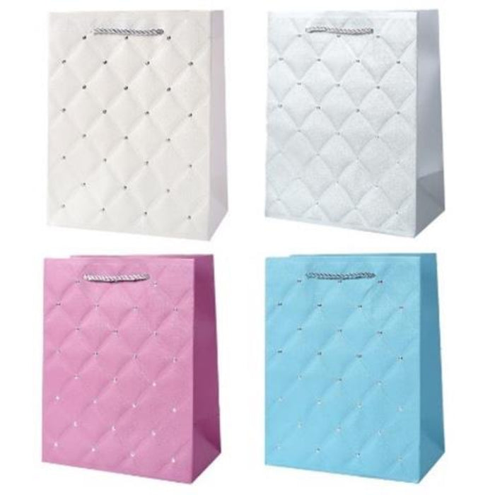 Four quilted paper shopping bags arranged in a 2x2 grid on a white background, featuring diamond-quilted patterns with small rhinestone-like accents in white, silver, pink, and light blue.