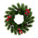 A green artificial pine wreath decorated with clusters of red berries and brown pinecones, isolated on a white background.