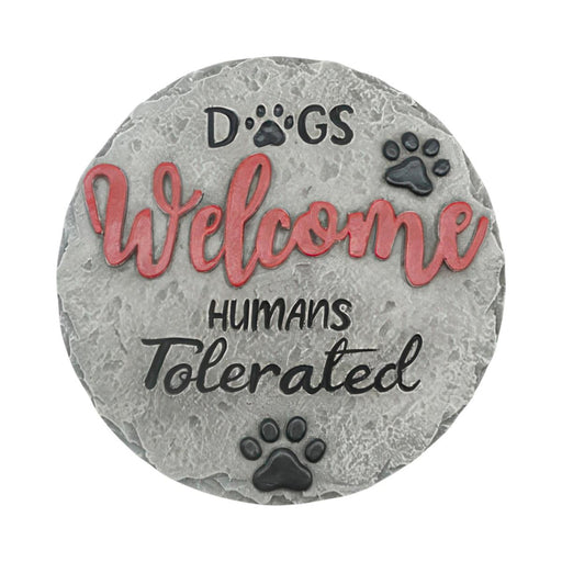 Decorative stone with 'Dogs Welcome, Humans Tolerated' text and paw prints on a white background