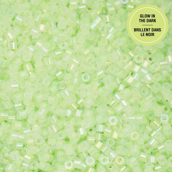 Close-up of green glow-in-the-dark beads with a label on a green background.