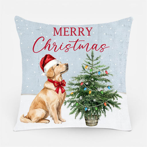 A square decorative throw pillow featuring a Christmas design with the text 'MERRY Christmas' in red script and serif lettering. The pillow shows a golden retriever wearing a red Santa hat and bow, next to a decorated Christmas tree, on a light blue and white background with subtle snowflake details.