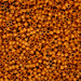 Close-up of a large pile of small, round, orange beads.