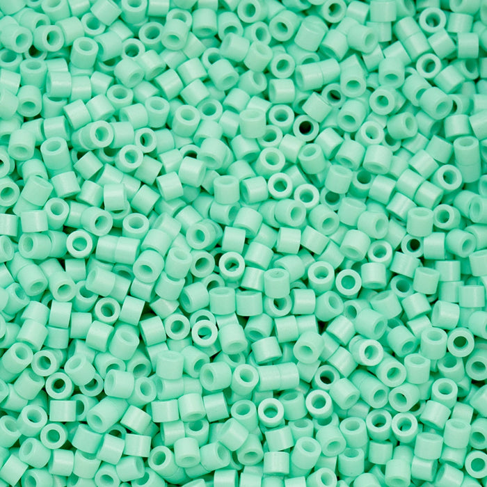 Close-up of a pile of light green plastic beads