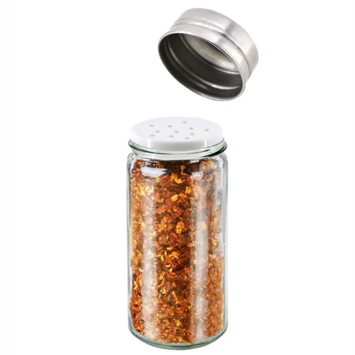 Glass spice jar with metal lid filled with red pepper flakes on a white background