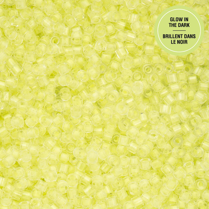 Close-up of small lime green beads with a label indicating 'Glow in the Dark' on a matching background.