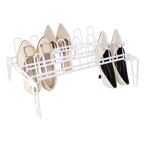 White shoe rack holding four pairs of pointed-toe shoes on a white background